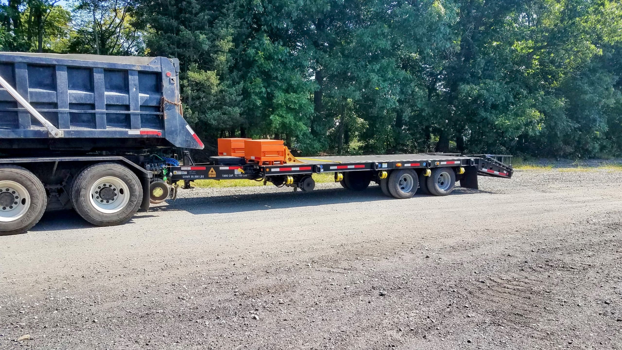 Truck pulling a tag along hi rail trailer built by DymaxRail
