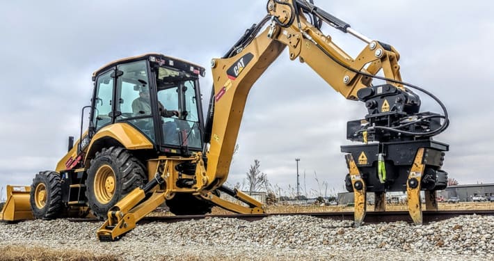 DymaxRail Series 14 ballast tamper attachment for excavators, backhoes, and grapple trucks
