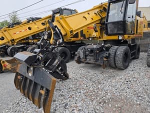 Gradall excavator with a 360 rotating quick coupler and a ballast blade attached to coupler