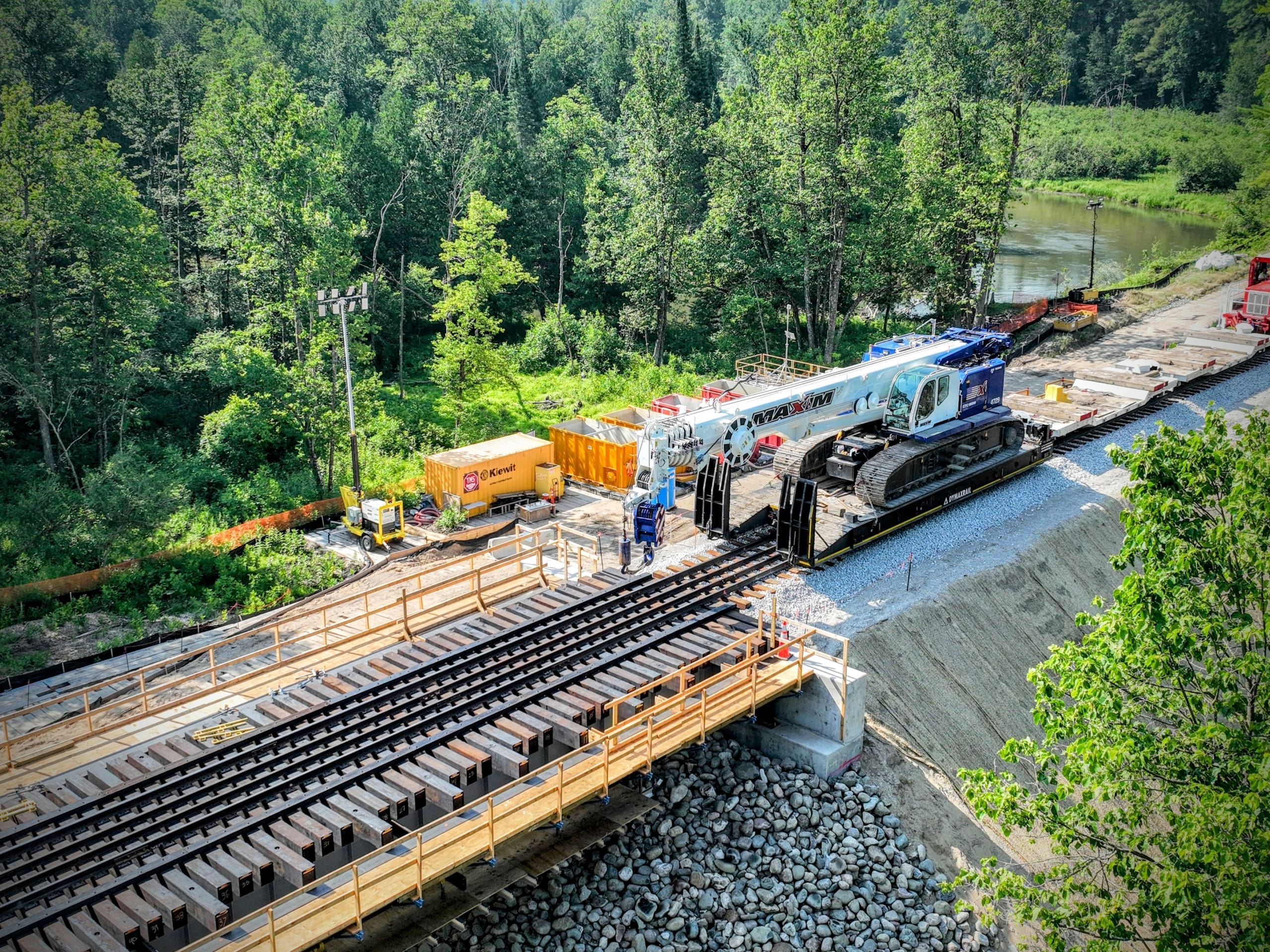 Crawler crane delivered to the bridge replacement site using rail-based equipment transport.