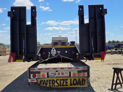 Oversize-load transport moving the DymaxRail 100-ton Machinery Cart to the Michigan bridge job.