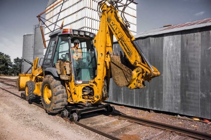 Case 580 or 590 backhoe loader configured for the Dymax Rail Rider hi-rail guide system