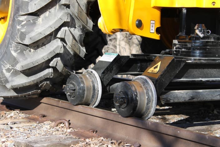 Rail Rider hi-rail dolly close-up Close-up of the Dymax Rail Rider rear dolly supporting a backhoe loader on rail