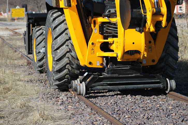 Rail Rider standard backhoe hi-rail application Standard backhoe loader fitted with the Dymax Rail Rider hi-rail guide system in rail application