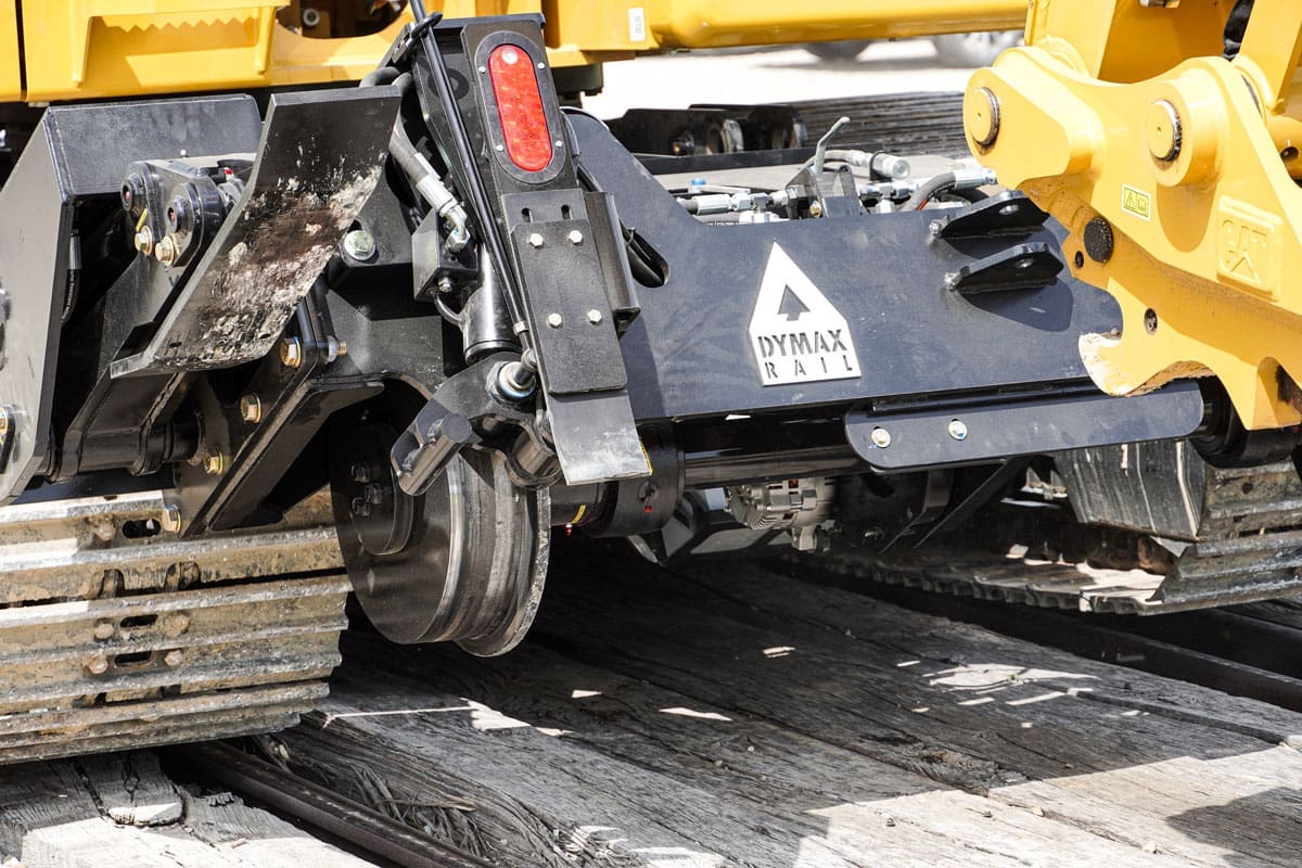 Close-up of the Dymax Rail Rider X2 patent-pending wedge-locking adapter that secures the hi-rail frame to the excavator without cutting, welding, or permanent machine modifications