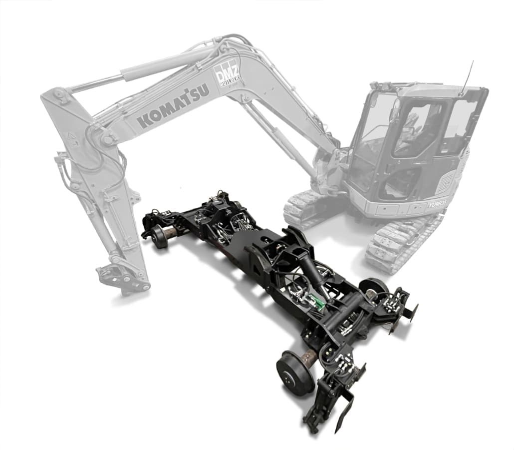 3D rendering of the Dymax Rail Rider 8T detachable hi-rail frame separated from a Komatsu 8-ton track excavator, showing the fully removable design that requires no machine modifications