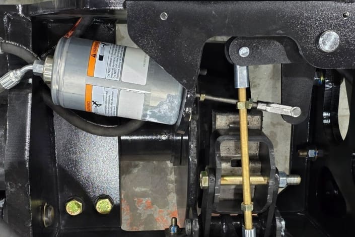 Close-up of the Dymax Rail Rider X2-15T spring-applied hydraulic release (SAHR) braking system, providing dependable stopping power with a manual hydraulic hand pump backup